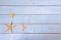 Sea stars. Summer nautical background - stars on wooden blue background