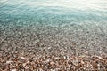 Sea stone pebble beach with colorful stones, transparent blue wave Royalty Free Stock Photo