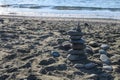 sea ??stones against the backdrop of the beach in the form of a stone tower, summer vacation 1 Royalty Free Stock Photo