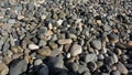 Sea stones background with small pebbles or stone in garden or in the seaside or on a beach. A close up view of rounded