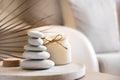 Sea stones balance and candle on wooden table, spa and relax concept, space for text, selective focus horizontal banner Royalty Free Stock Photo