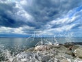 Sea and stones  blue dramatic cloudy sky water splash stormy weather nature  landscape panorama  wild nature Royalty Free Stock Photo