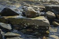 Sea stones and rocks of different sizes and texsture of black, gray and brown on the Black Sea coast as nature bacground. Royalty Free Stock Photo