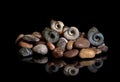 Sea stones, shells are isolated on a black background. In reflection