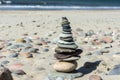 Sea stones stacked one on top of another, a pyramid of flat stones, stones on the sea sand