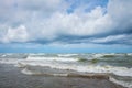 Sea storm. Big waves and strong wind in the sea. Clouds in sky over raging ocean
