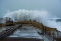 Sea storm waves crashing and splashing against jetty