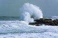 Sea storm waves crashing and splashing against jetty