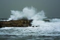 Sea storm waves crashing and splashing against jetty