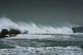 Sea storm waves dramatically crashing and splashing against rocks Royalty Free Stock Photo