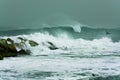 Sea storm waves dramatically crashing and splashing against rocks