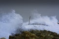 Sea storm waves dramatically crashing and splashing against rocks