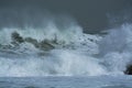 Sea storm waves dramatically crashing and splashing against rocks