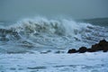 Sea storm waves dramatically crashing and splashing against rocks