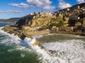 Sea storm and waves with wind. Aerial view of Pizzo Calabro, broken pier, castle, Calabria, tourism Italy. Houses on the rock.