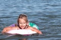 Sea, summer, child, girl, five-year-old, blonde, floats on an inflatable lifebuoy
