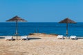 Sea with sun umbrella, white deckchair on flagged stone beach. Vactaion, travel background, Croatia, Istria