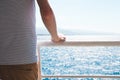 Sea, sun, white, blue, man, boat, summer. Young man staying on the board of a ship. Close up