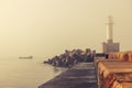 Sea sunrise. Foggy morning over the harbour and sailing fishing boat Royalty Free Stock Photo