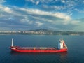 Sea sunrise over ocean horizon and sailing industrial cargo ship in deep blue open waters, aerial view Royalty Free Stock Photo