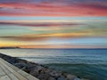 Sea sunset colorful evening sky and moon on cloudy  skyline,  light reflection on seawater, gold summer city  in   Tallinn old tow Royalty Free Stock Photo