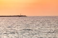 Sea sunset over pier. Beautiful seascape. Dreams of travel and freedom. Buoys at sea. Sundown sky and claim weather Royalty Free Stock Photo