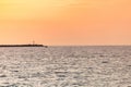 Sea sunset over pier. Beautiful seascape. Dreams of travel and freedom. Buoys at sea. Sundown sky and claim weather Royalty Free Stock Photo