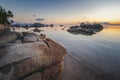 Sea sunset rocks beach on blue sky background. Beauty evening sunrise. Sandy beach with rocks