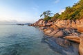 Sea sunset rocks beach on blue sky background. Beauty evening sunrise. Blue background.