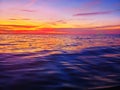 Sea sunset soft blurred background, ocean sunrise, tropical island beach dawn, dark blue water waves, colorful clouds sky Royalty Free Stock Photo