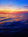 Sea sunset soft blurred background, ocean sunrise, tropical island beach dawn, dark blue water waves, colorful clouds sky Royalty Free Stock Photo