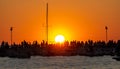 Sea sunset with yacht and people on the pier seeing the sun off Royalty Free Stock Photo