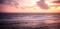 Sea surf waves on Bali beach Melasti sunset scenery with sea horizon with sunset sky with pink orange clouds with surf waves Royalty Free Stock Photo