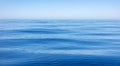 Sea water surface calm with small ripples. Still ocean, deep blue color background Royalty Free Stock Photo