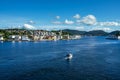 Sea surrounding Kristiansund covered in greenery and buildings under the sunlight in Norway