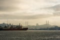 The sea trade port of Vladivostok on the background of the Golden Bridge across the Golden Horn Bay in the rays of the rising sun Royalty Free Stock Photo