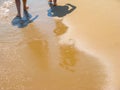 The sea transparent clear wave gradually washes away traces on the sand left by happy people Royalty Free Stock Photo