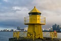 Sea transportation and navigation. Lighthouse on sea pier in reykjavik iceland. Lighthouse yellow bright tower at sea Royalty Free Stock Photo