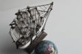 Sea Travel Concept Image. Globe And Wooden Model Of Old Ship In Muted Colors Style Royalty Free Stock Photo