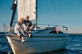 Sea trip. Happy beautiful senior family couple hugging and having fun while relaxing on a sail boat or yacht deck Royalty Free Stock Photo