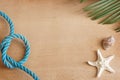 Sea tropical still life on a wooden background with a starfish, a leaf of a palm tree and a blue rope tied to a knot, copy space f Royalty Free Stock Photo