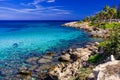 Sea turquoise water, stone beach and blue sky landscape in Fig Tree Bay, Protaras, Cyprus Royalty Free Stock Photo