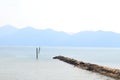 The sea is very calm with gentle ripples. Background of sky and sea