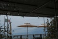 sea view across the open-air cafe on the beach and sun umbrellas, and the Italian flag. Ligurian sea, Sestre Levante, Liguria Royalty Free Stock Photo