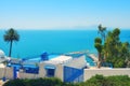 Sea view and arabic cafe with palm tree in Sidi Bou Said. House white and blue color - Sidi Bou Said, Tunisia, 06 18 2019