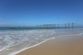 The beach front view overlooks the old wooden bridge in summer, suitable for surfing