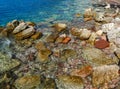 The sea view. Beautiful view from the mountain to the calm Adriatic sea. Blue clear water and large stones.