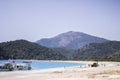 A sea view of the beautiful Oludeniz Beach with a digger and workmen on the white sand