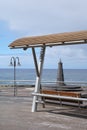 Sea view with bench and small lighthouse