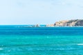 Sea view and blueish sky in Kilyos, cliffs and lighthouse at the far end, Black Sea Region in Istanbul